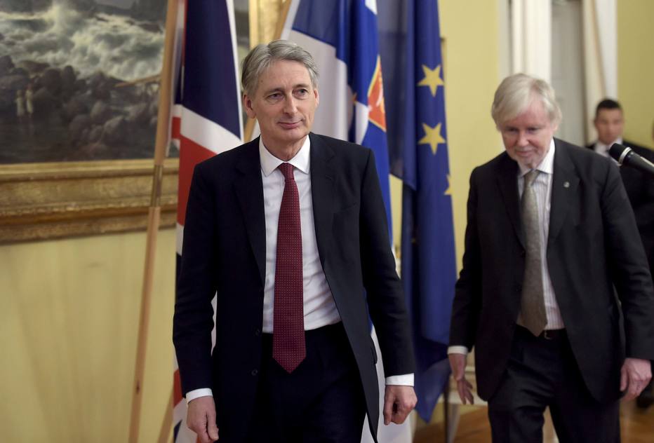 British Foreign Secretary Philip Hammond (L) walks during a meeting with Finnish Foreign Minister Erkki Tuomioja (R) in Helsinki, January 8, 2015. REUTERS/Markku Ulander/Lehtikuva (FINLAND - Tags: POLITICS) ATTENTION EDITORS - THIS IMAGE HAS BEEN SUPPLIED BY A THIRD PARTY. IT IS DISTRIBUTED, EXACTLY AS RECEIVED BY REUTERS, AS A SERVICE TO CLIENTS. NO THIRD PARTY SALES. NOT FOR USE BY REUTERS THIRD PARTY DISTRIBUTORS. FINLAND OUT. NO COMMERCIAL OR EDITORIAL SALES IN FINLAND